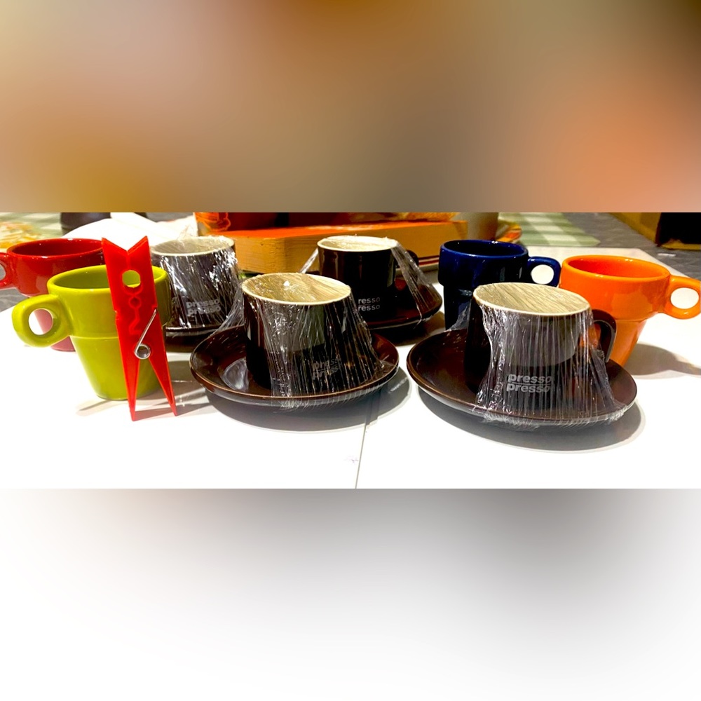 Four small expressions cups and saucers. With colored mini mugs